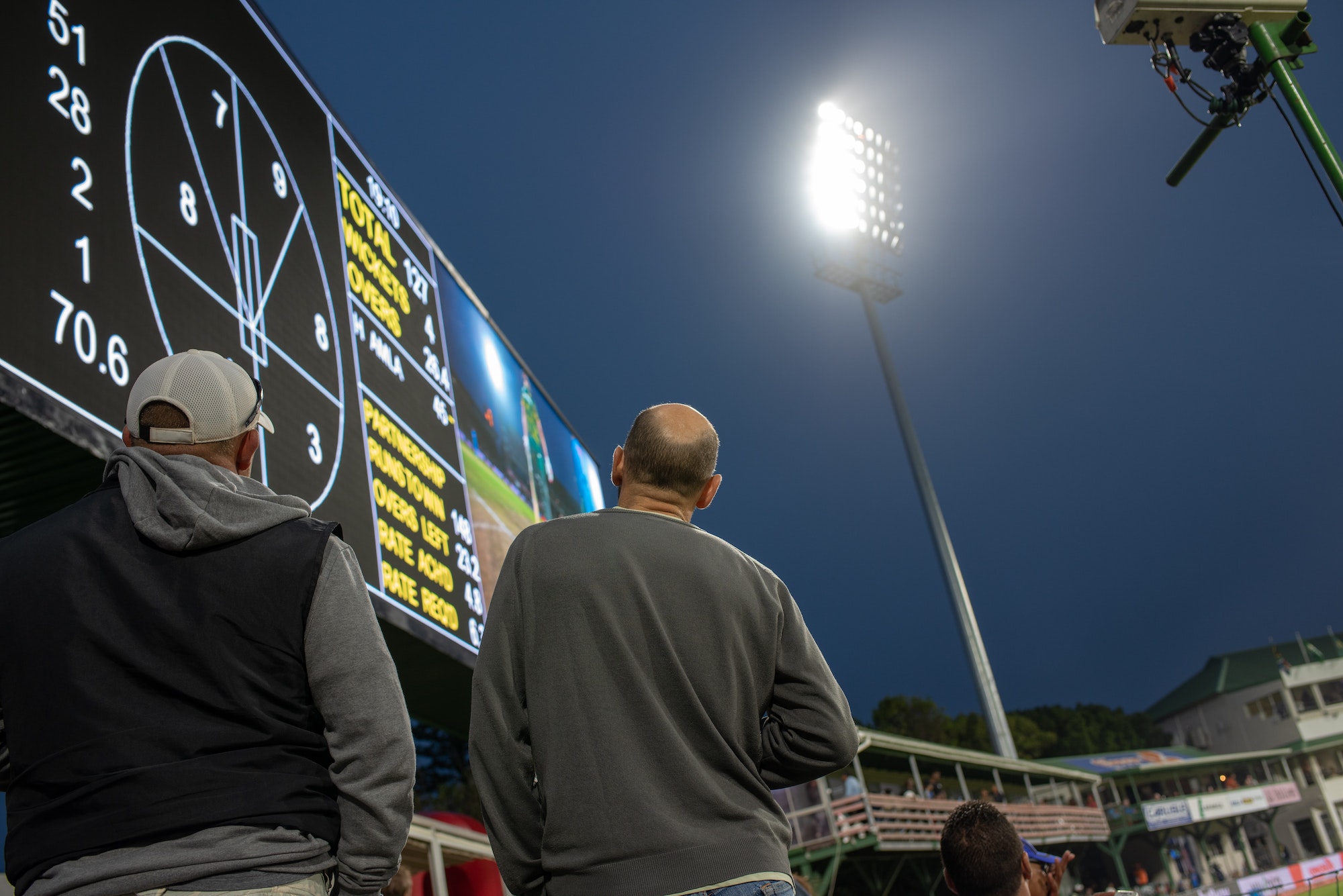 Fans looking at cricket scoreboard
